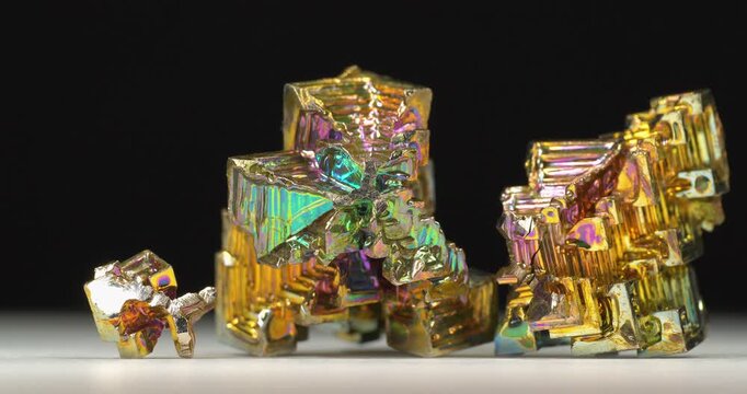 Bismuth crystals. Bismuth - chemical element with symbol Bi and atomic number 83. Post-transition metal and one of pnictogens. Synthesized bismuth crystal. Iridescent coloration is due to oxide film