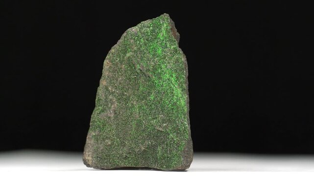Uvarovite - calcium-chromium silicate mineral, an emerald-green variety of garnet. Small green crystals on the stone surface