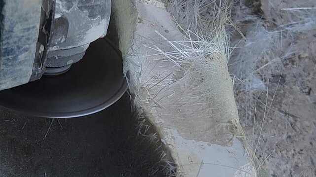 Close-up of a skilled artist using an angle grinder to cut and shape a fibre sculpture, captured in slow motion. The scene highlights precision craftsmanship, manual work, and industrial tools, India
