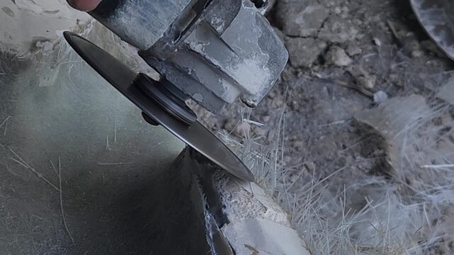 Close-up of a skilled artist using an angle grinder to cut and shape a fibre sculpture, captured in slow motion. The scene highlights precision craftsmanship, manual work, and industrial tools, India