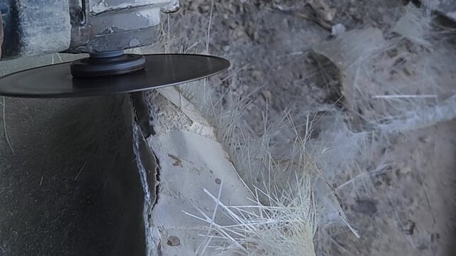 Close-up of a skilled artist using an angle grinder to cut and shape a fibre sculpture, captured in slow motion. The scene highlights precision craftsmanship, manual work, and industrial tools, India