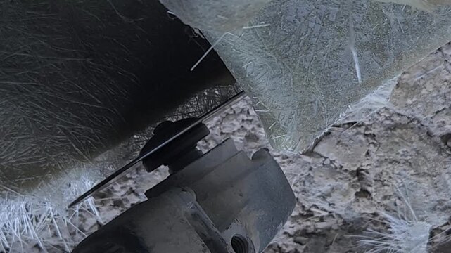 Close-up of a skilled artist using an angle grinder to cut and shape a fibre sculpture, captured in slow motion. The scene highlights precision craftsmanship, manual work, and industrial tools, India