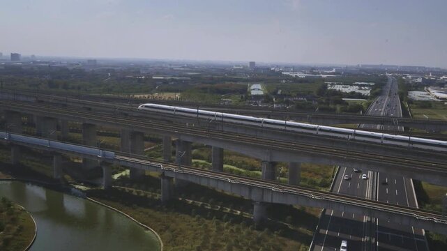 High-speed railway train traveling on the Beijing&ndash;Shanghai High-Speed Railway (Jinghu HSR) in China. Modern bullet train running on elevated tracks through the countryside, showcasing advanced transpo