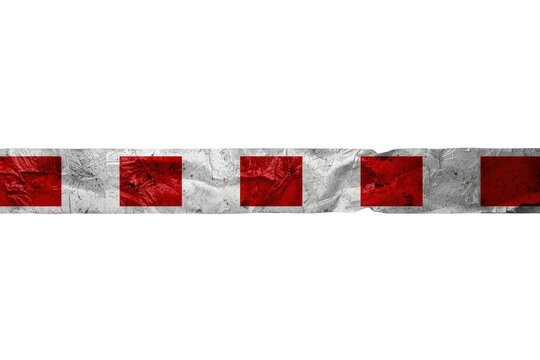Crumpled red and white barrier tape marking a restricted area, symbolizing caution, danger, or an urgent warning