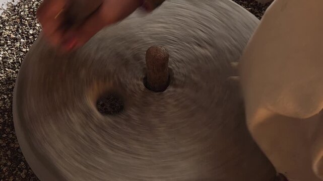 Traditional Stone Grinder in Motion, Manual Grain Grinding Process and Rural Food Preparation Close Up