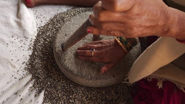 Traditional Stone Grinder in Motion, Manual Grain Grinding Process and Rural Food Preparation Close Up