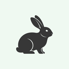 Fototapeta premium Simple Silhouette of a Cute Rabbit Sitting and Looking to the Side.