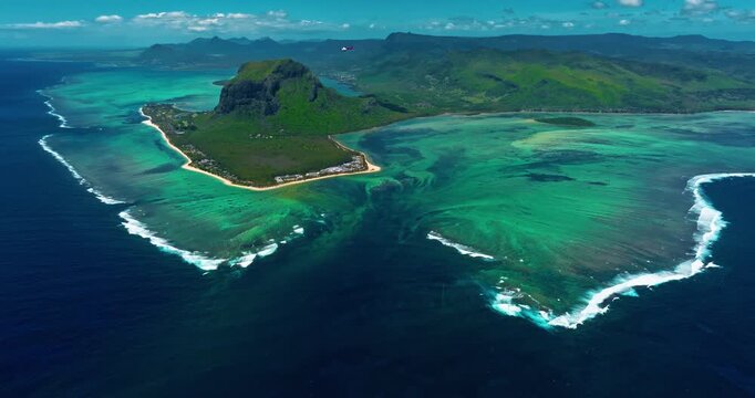 Aerial view of Le Morne Peninsula, Le Morne Brabant Mountain. Sea lagoon formed by coral reefs, Mauritius Island, Africa, Indian Ocean. Underwater waterfall in Le Morne