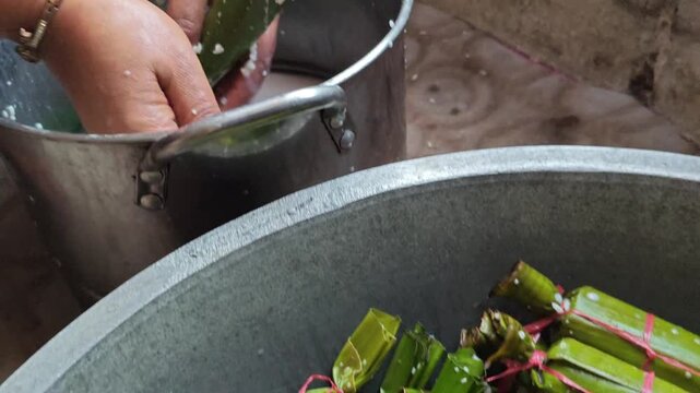 Traditional lemang cooking in bamboo with coconut milk and rice, festive Indonesian dish prepared for Eid celebrations and cultural ceremonies.