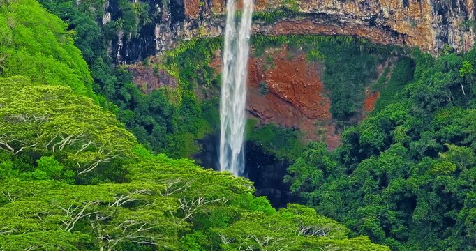 Aerial view of Chamarel Waterfall, plunging from verdant cliff into shadowy, the highest waterfall on the island, Mauritius island