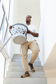 Man starting descent carrying laundry basket for home animated UI guiding path and showing progress