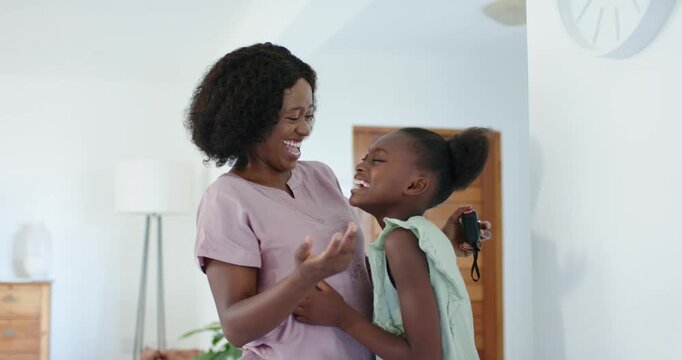 Vertical video: Mom hugging daughter in home entry after showing device, in pink top, green dress