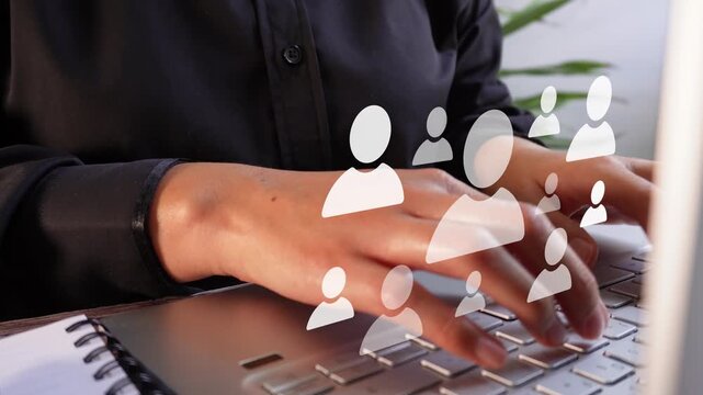 Close-up of a businesswoman working on her computer with an animation highlighting different avatars, a concept related to recruitment.