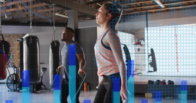 Man and woman starting cue, matching jump-rope hops for cardio in gym while blue graphs overlaying