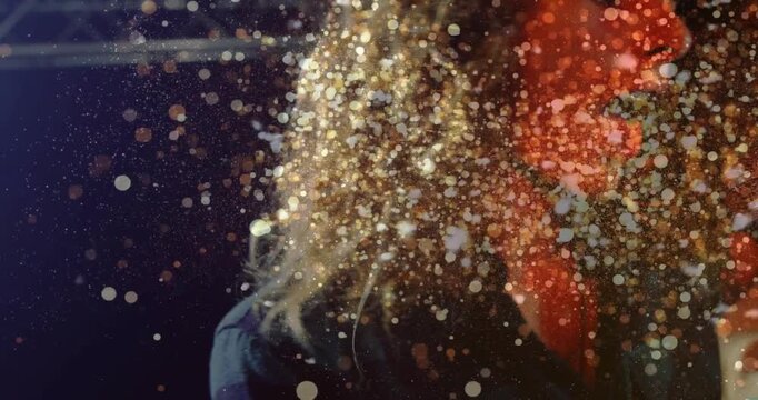 Singer launching note, moving hands on mic, particles cascading around face and mic for music show