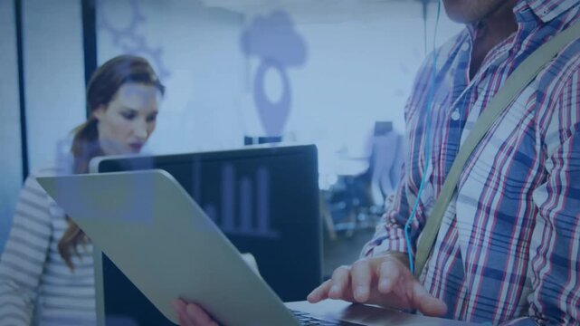 Man tapping laptop and smiling, causing cloud pin gear chart overlays on glass for business review