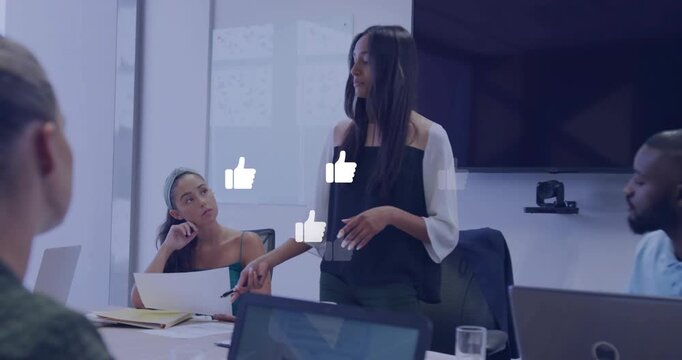 Presenter standing and speaking in business, causing thumbs-up icons growing while sharing update