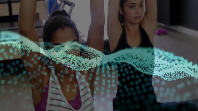 Women on coach cue lifting arms overhead on mats in fitness with turquoise overlay crossing faces