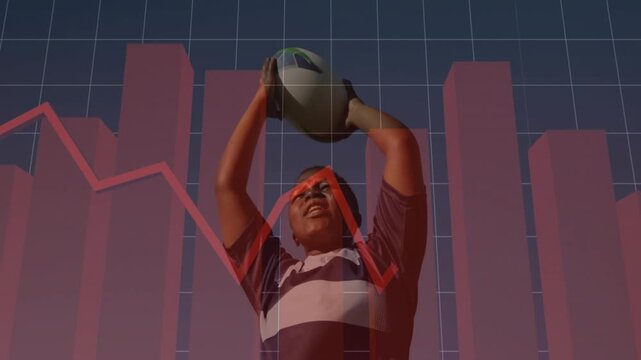 Doing passes, athlete in rugby shirt holding oval ball overhead for studio study with red charts