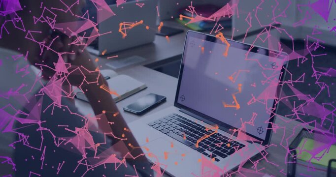 Man adjusting posture on pink-orange particle overlay appearing, drifting over laptop for design