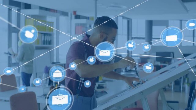 Designer leaning at draft table, using stylus, single mail sparking blue net moving and hiding plan