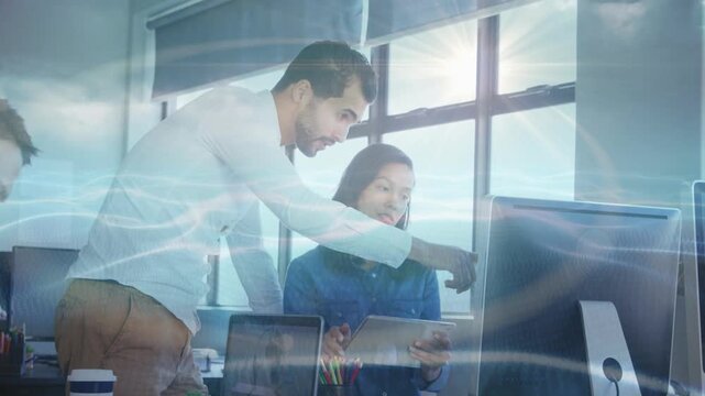 Vertical video: Business lead leaning over desk pointing tablet, screen, blue overlay urging action