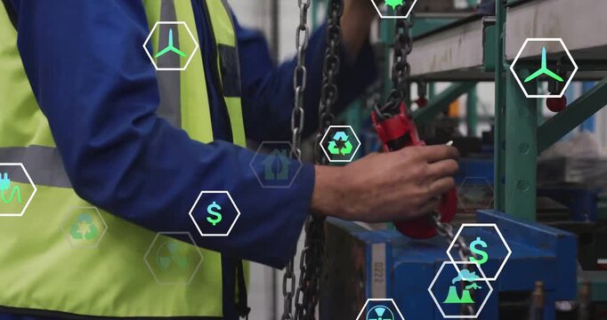 Vertical video: Rigger pulling chain, hooking red hoist to blue load, securing lift amid hex icons