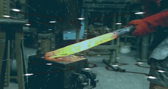 Male metalworker holding tongs, positioning glowing billet on anvil, hammer striking, sparks flying