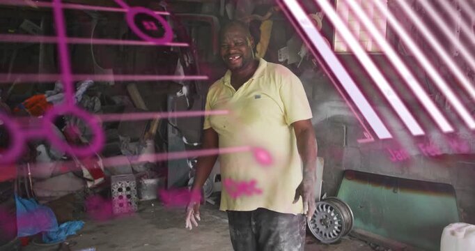 Vertical video: Man in auto workshop responding to magenta overlays, shifting and gesturing