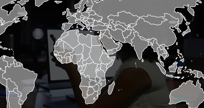 Office woman raising smartphone, causing business map overlay sharpening while checking laptop data