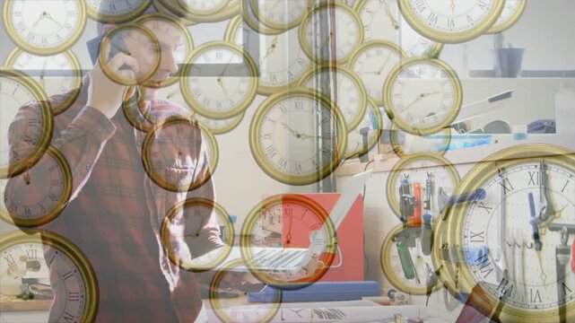 On receiving call man holding phone, confirming repair in workshop, clocks obscuring man and bench