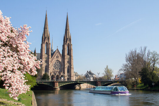 Boat passing by Saint-Paul Church Strasbourg in spring, Strasbourg