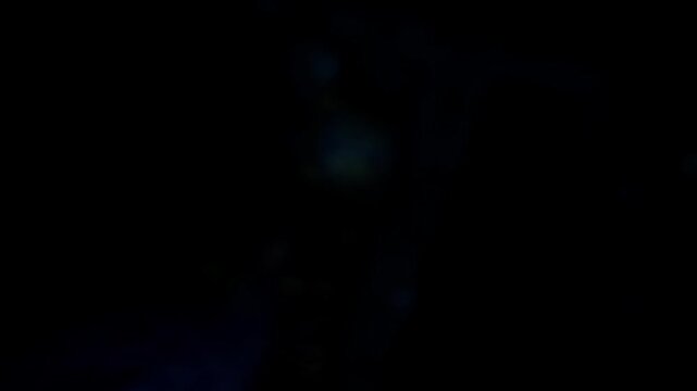 Abstract footage of flowing blue smoke drifting gracefully against a dark black background, creating a dramatic and cinematic atmospheric effect. The soft swirling vapor patterns