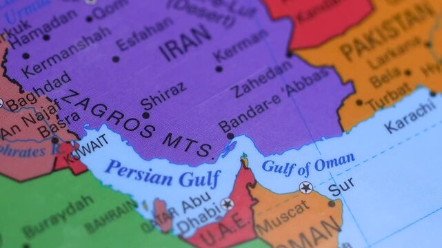 Concept of Persian Gulf and Hormuz strait conflict and tension on a world map with warning sign.