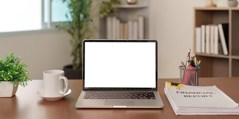 Fototapeta premium Professional desk setup with financial report and laptop