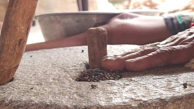 Close-Up of Woman Hand Operating Traditional Stone Grinder Chakki in India, Manual Grain Grinding Process, Rural Kitchen Tool, Authentic Village Lifestyle, Organic Food Preparation 4K Footage