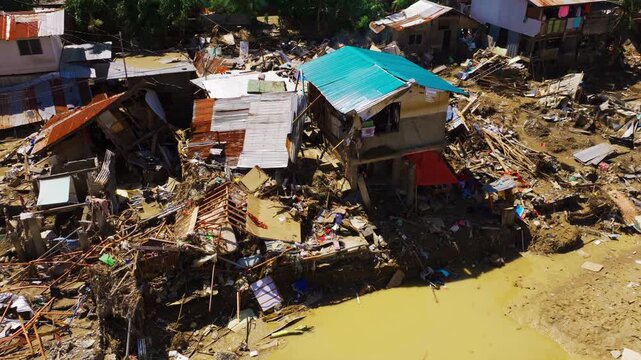 Destroyed riverside homes in Cebu after typhoon flooding and climate storms