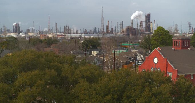 Drone footage revealing petrochemical refineries and smokestacks visible from Baytown residential neighborhoods