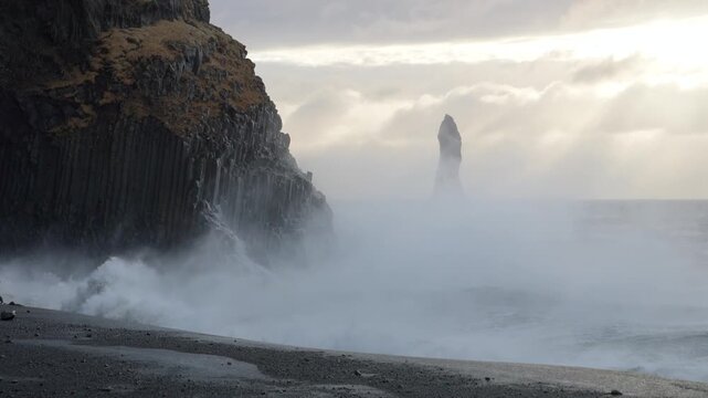 Reynisfjara Beach, Iceland - Waves Crash Against the Basalt Columns Along the Misty Shore - Wide Shot
