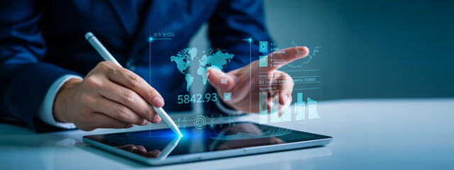 Fototapeta premium Man analyzing global financial data on futuristic tablet with augmented reality interface for business growth