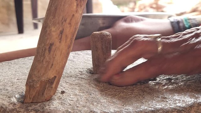 Close-Up of Woman Hand Operating Traditional Stone Grinder Chakki in India, Manual Grain Grinding Process, Rural Kitchen Tool, Authentic Village Lifestyle, Organic Food Preparation 4K Footage