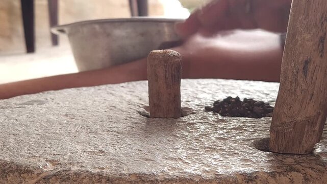 Close-Up of Woman Hand Operating Traditional Stone Grinder Chakki in India, Manual Grain Grinding Process, Rural Kitchen Tool, Authentic Village Lifestyle, Organic Food Preparation 4K Footage