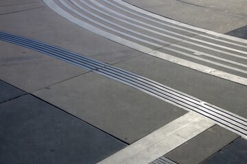 Fototapeta premium Abstract textured concrete surface with curved and straight grooves