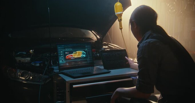 Technician Seen Multitasking Digital Workstation in Sunlit Garage. Laptop Screen Displays 3D Thermal and Structural Map of Vehicle, While Girl Uses Tablet to Monitor Sensor Graphs and Telemetry Data.