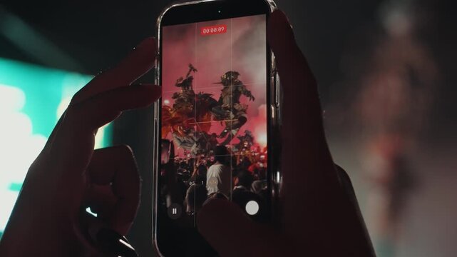 Ogoh Ogoh festival in Bali captured on smartphone by crowd at night, people recording traditional parade and ritual