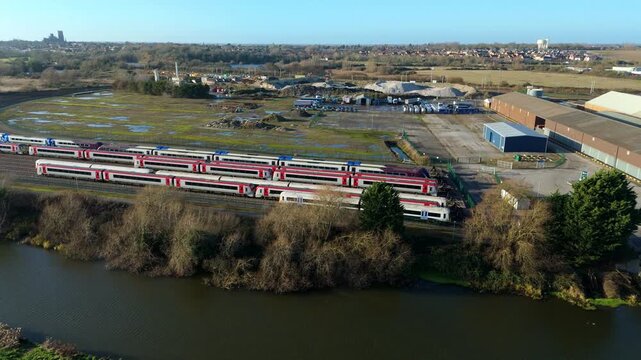 Aerial view of rail infrastructure and locomotive carriages at a train stabling yard near Ely during a bright sunny day in the United Kingdom