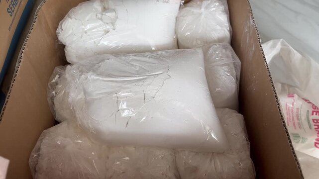 White Powder in Transparent Plastic Bags Inside a Cardboard Box