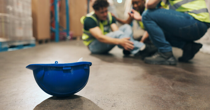 Helmet, slip and employee with injury in warehouse, logistics and stock distribution or supply chain. Shipping, loader and person with muscle tension, workplace accident and safety risk in factory