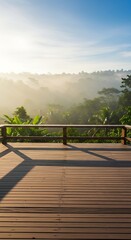 Fototapeta premium Wooden deck overlooking a misty tropical jungle landscape at sunrise