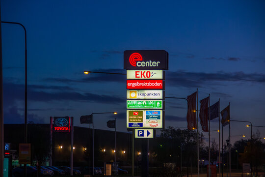 Malm&ouml;, Sweden - October 27 2019: Illuminated shopping center pylon sign at dusk with various brand logos outside ecenter at J&auml;gersro